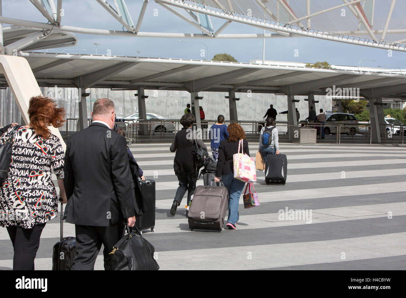 Travellers passengers at Adelaide international airport with suitcases
