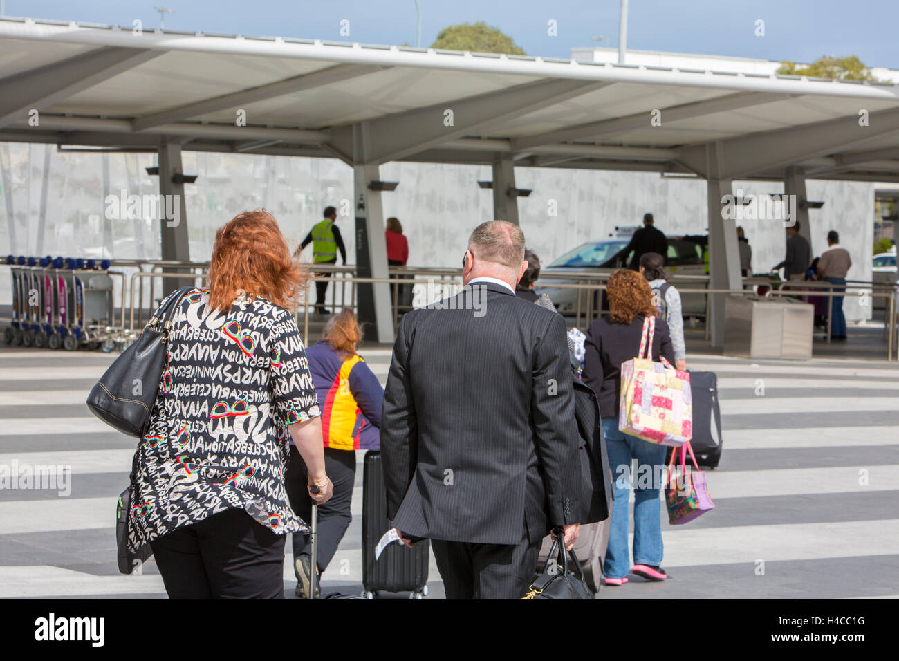 Travellers passengers at Adelaide international airport with suitcases