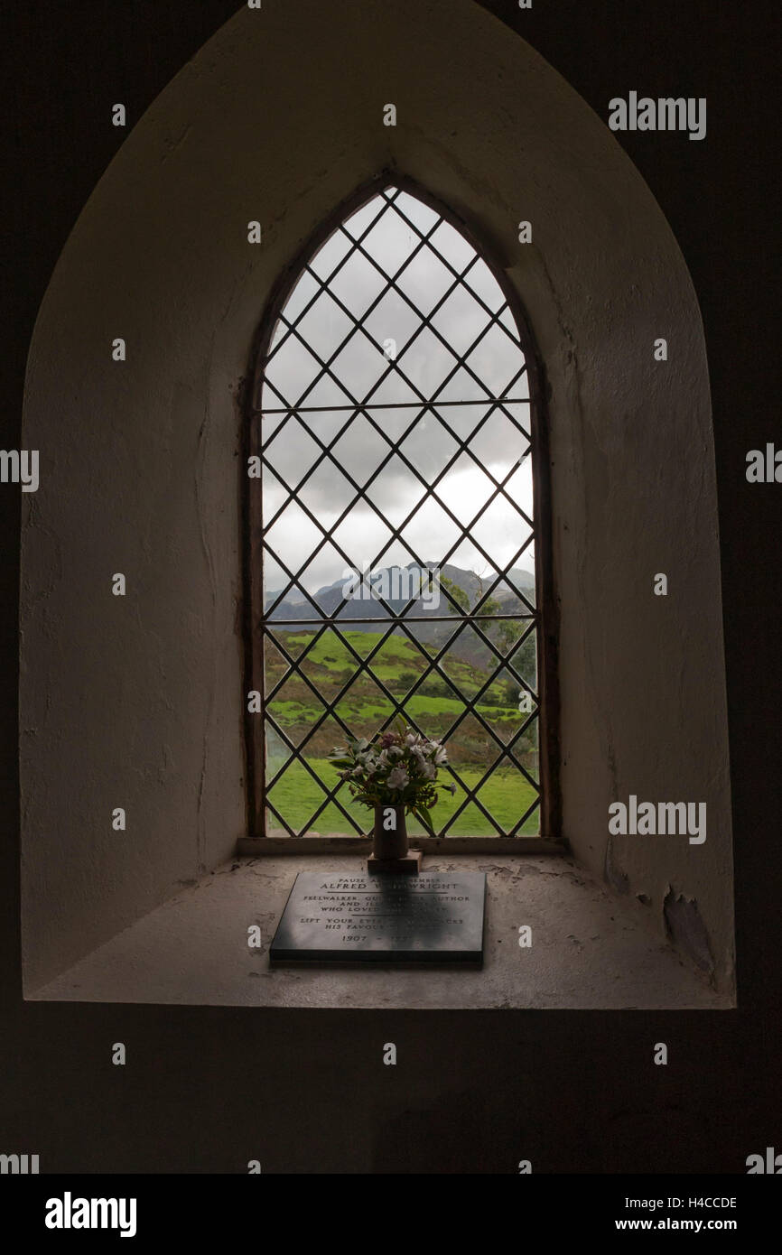 A view through the ornate window at St James Church in the village of Buttermere in Lake District National Park Stock Photo