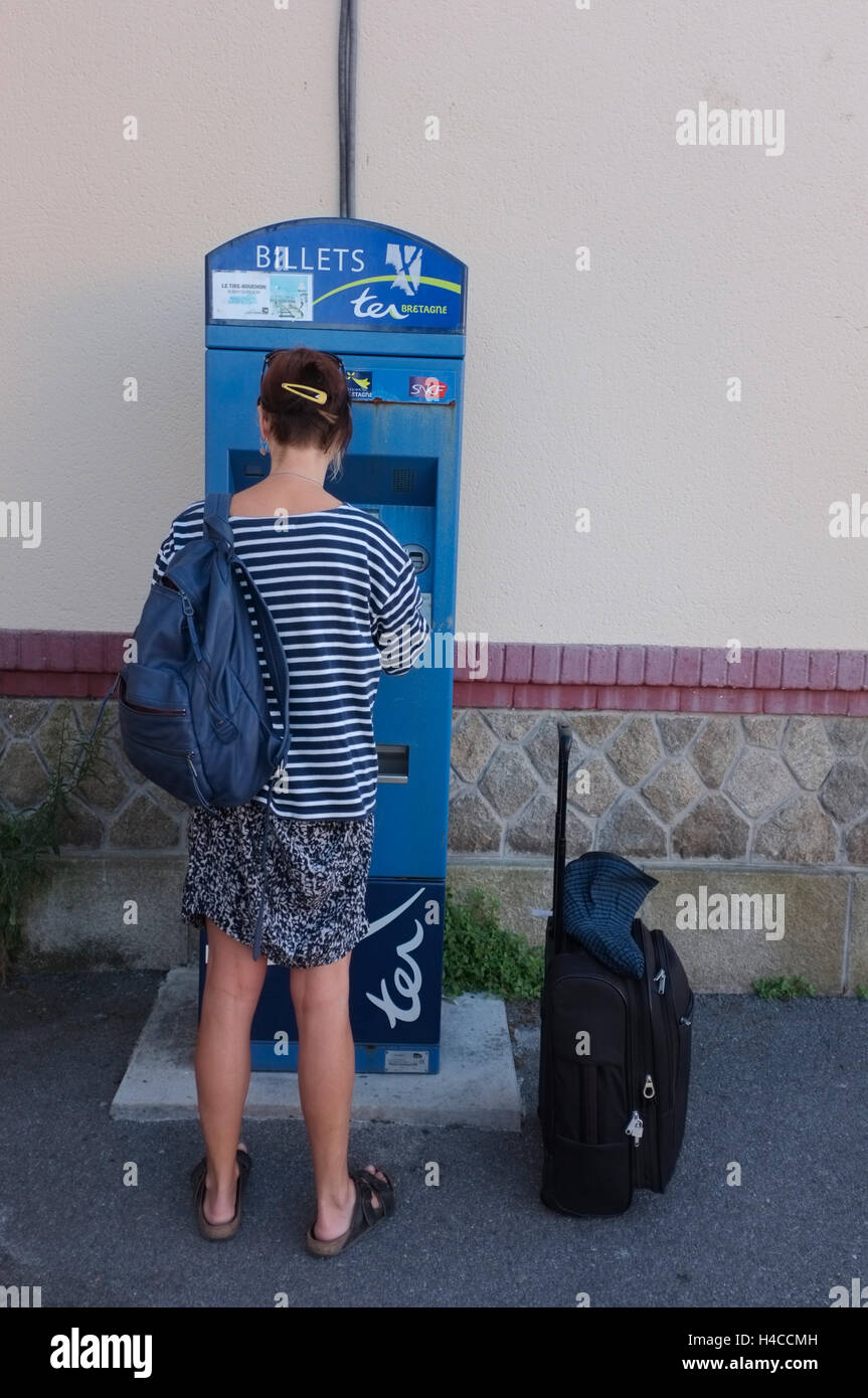 A tourist buys a train ticket at Quiberon station in Brittany, France Stock Photo