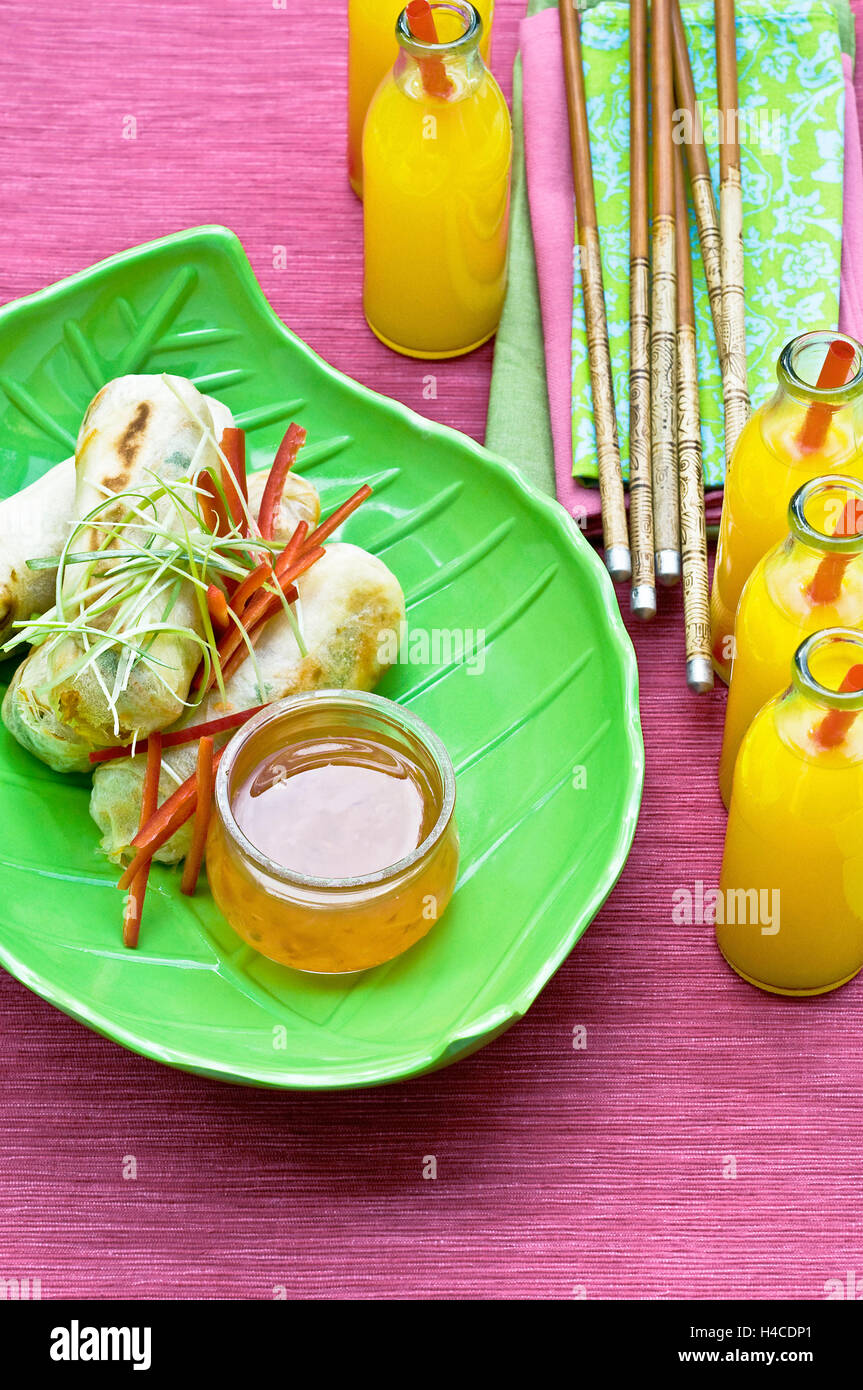 Egg rolls, chopsticks, lemonade bottles Stock Photo