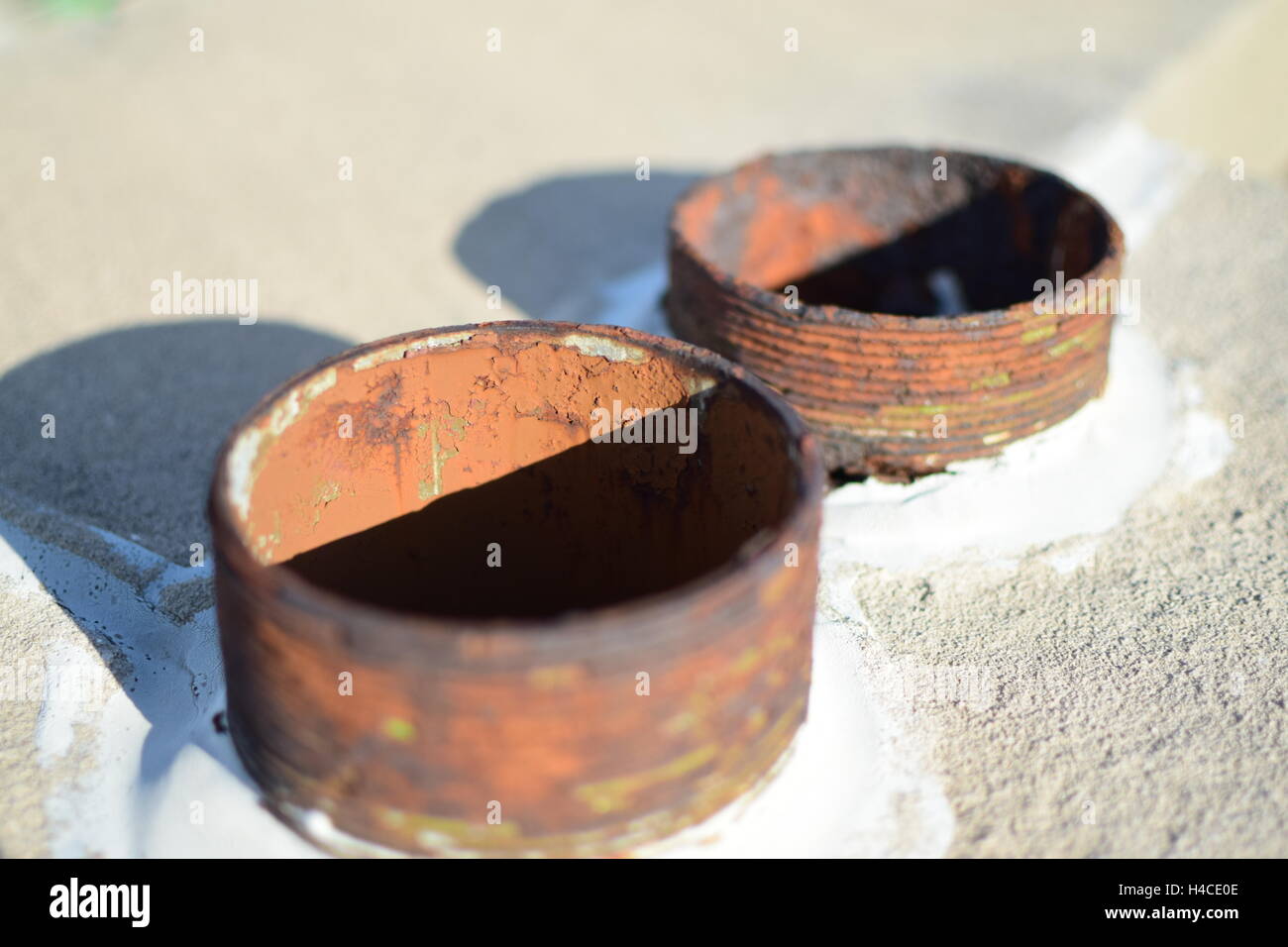 Rusty Weathered Drain Pipes in Concrete with a Shadow Stock Photo