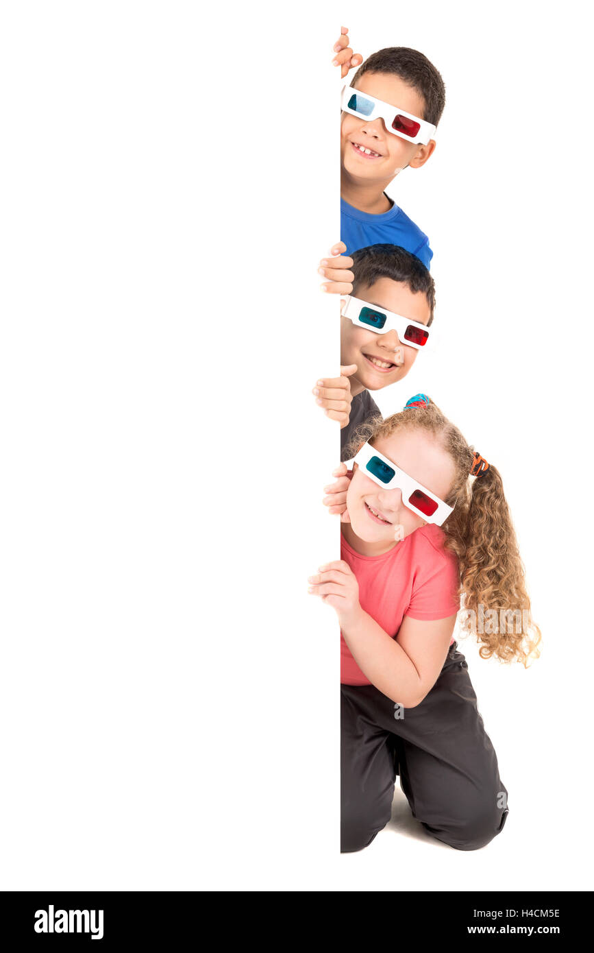 Group of children with 3d glasses over a white board Stock Photo