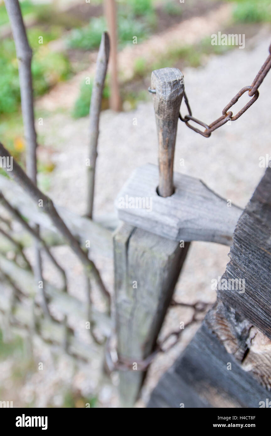 wooden gate in front of vegetable garden with wooden seal Stock Photo