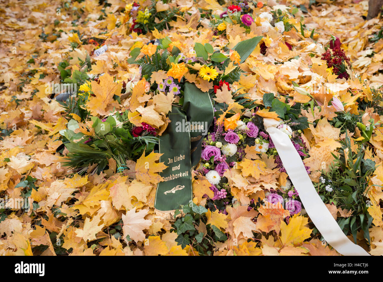 Tomb in autumn with mourning band Stock Photo
