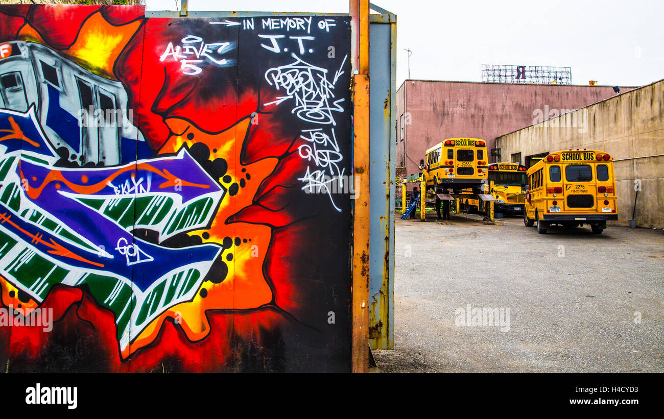 America, USA, New York, Brooklyn, Red Hook, school buses in the garage, graffiti Stock Photo