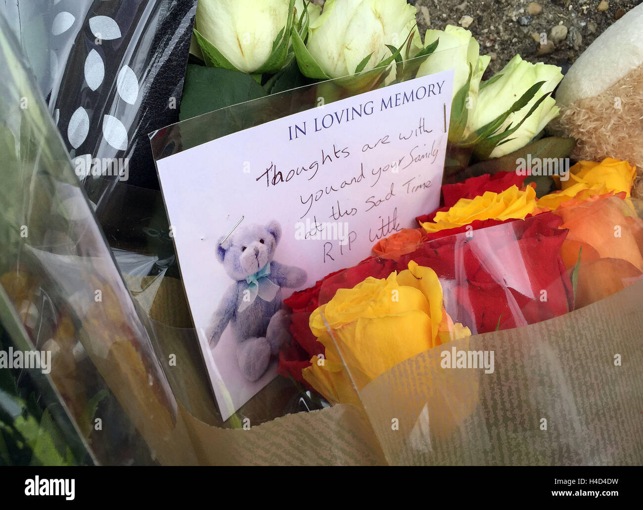 Floral tributes outside a house on the junction of Harwich Road with Tara Close in Colchester, Essex, after a baby boy was killed and a second child injured in a dog attack. Stock Photo