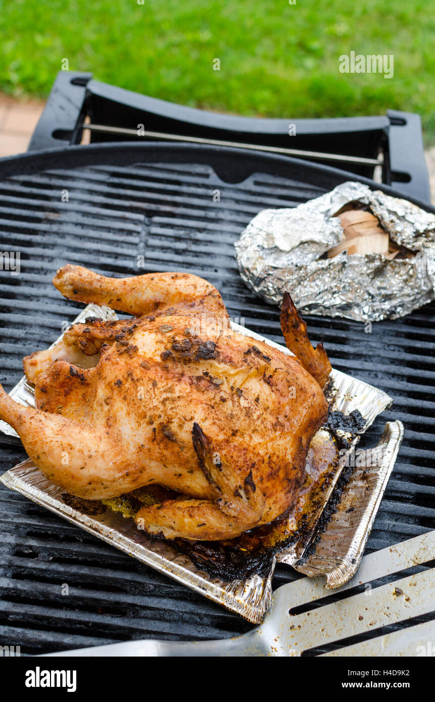 Grilled chicken whole and stuffed with herbs and nettles, czech beer Stock Photo