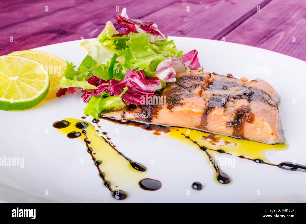 Salmon with a reduction of balsamic vinegar and sugar, fresh salad