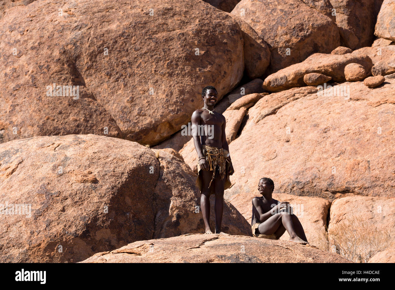 African hunter from Damara people stays near the hut in the village in Namibia, South Africa Stock Photo