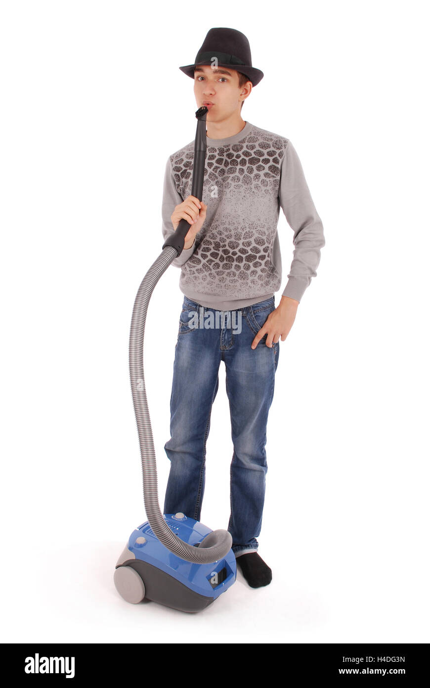 Boy in a hat holding a vacuum cleaner isolated on white background