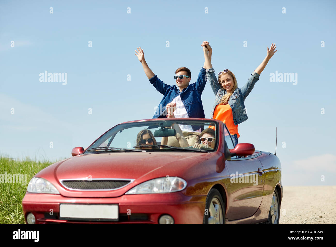 happy friends driving in cabriolet car at country Stock Photo - Alamy