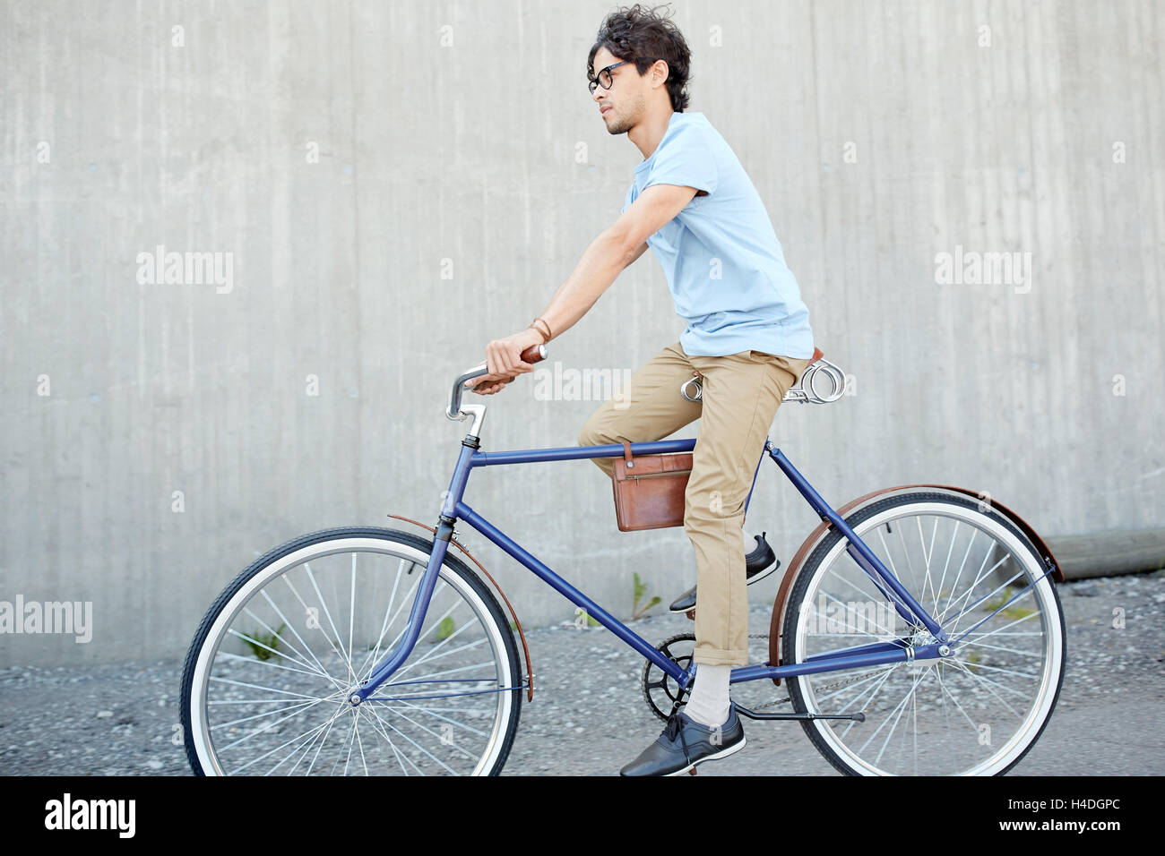 young hipster man riding fixed gear bike Stock Photo Alamy