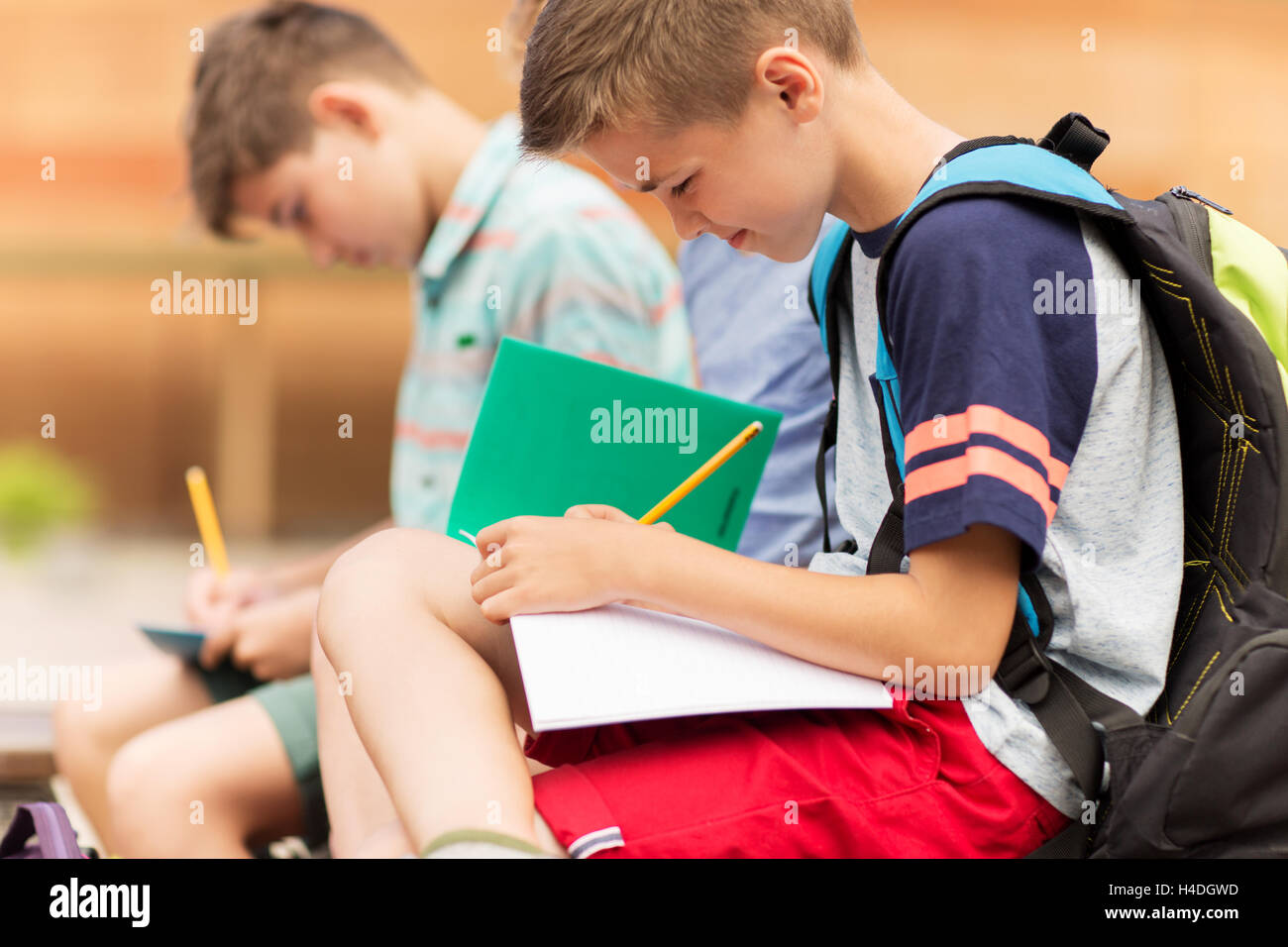 elementary school students writing to notebooks Stock Photo Alamy
