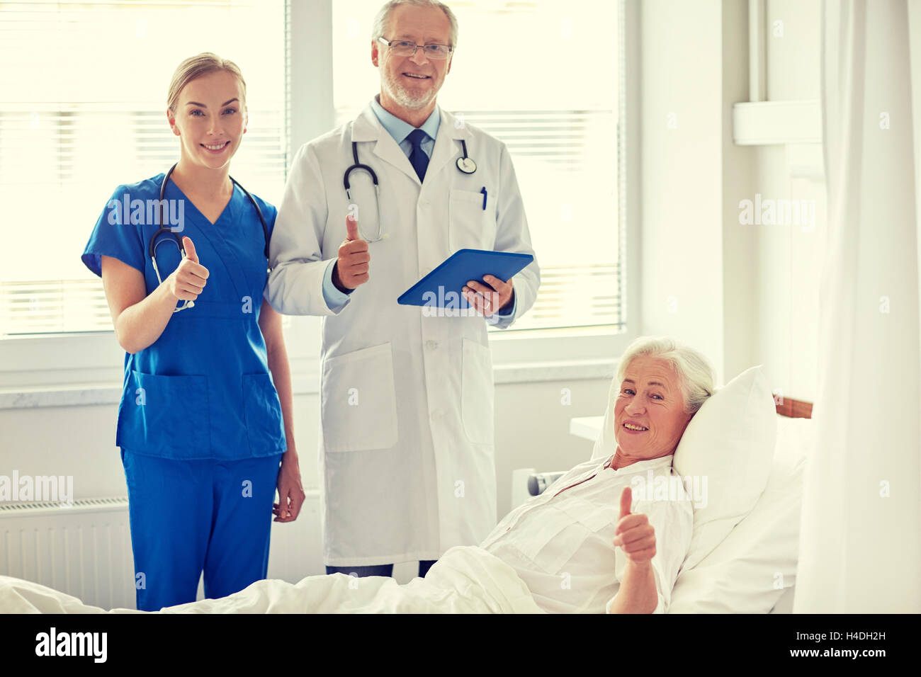 doctor and nurse visiting senior woman at hospital Stock Photo - Alamy