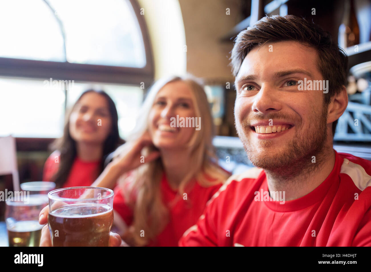 fans or friends watching football at sport bar Stock Photo Alamy