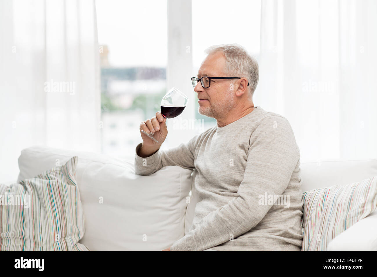 senior man drinking red wine from glass at home Stock Photo - Alamy