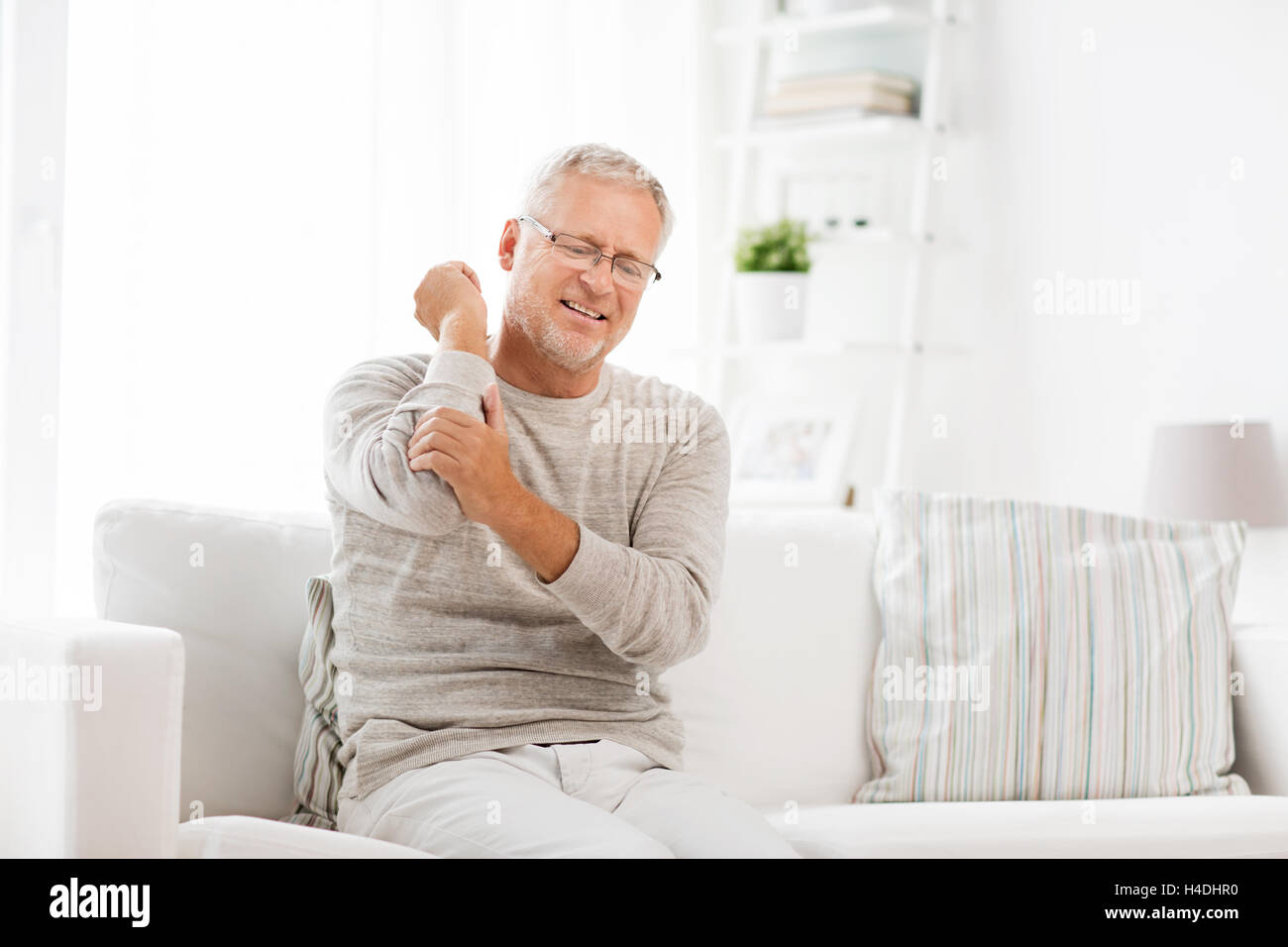 unhappy senior man suffering elbow pain at home Stock Photo - Alamy