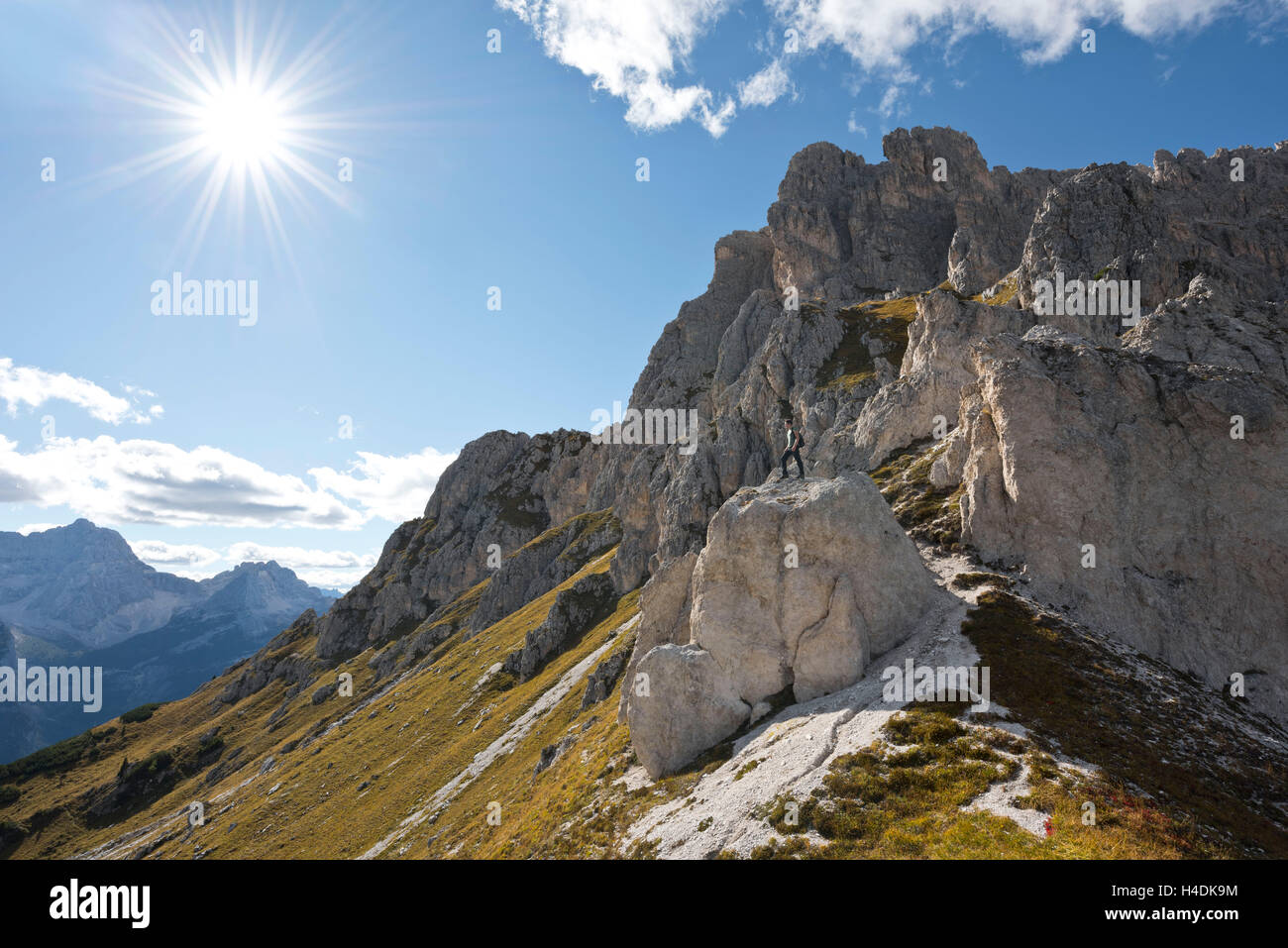 Italy, the Dolomites, alps, mountains, mountains, summits, weirdly, rocks, person, person, view, width, mountaineering, Grupo, Cadini, Cortina, d'Ampezzo, autumn, heaven, blue, scenery, nature, epically, to Sonnenstern, the sun, back light Stock Photo