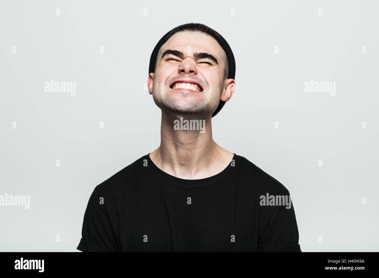 Man feeling exquisite pain while grinning Stock Photo