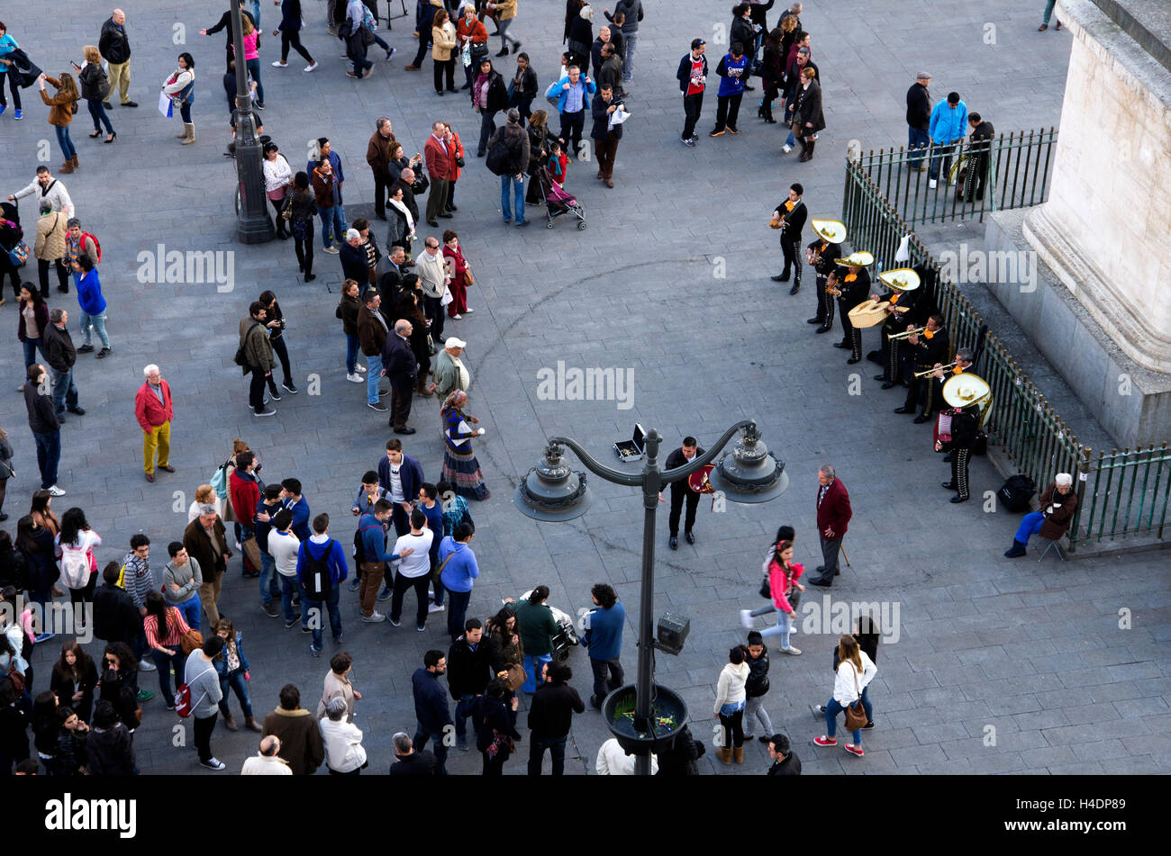 Puerta del Sol, Mexican Mariachi band plays for crowd while tourist watch, photograph, beg or sell something. Stock Photo