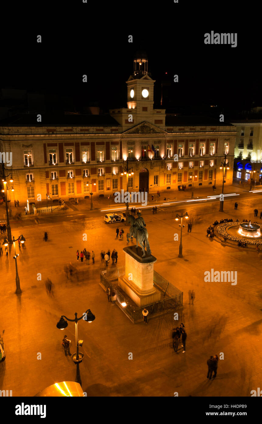 Puerta del Sol, people mill around the plaza at night. Stock Photo