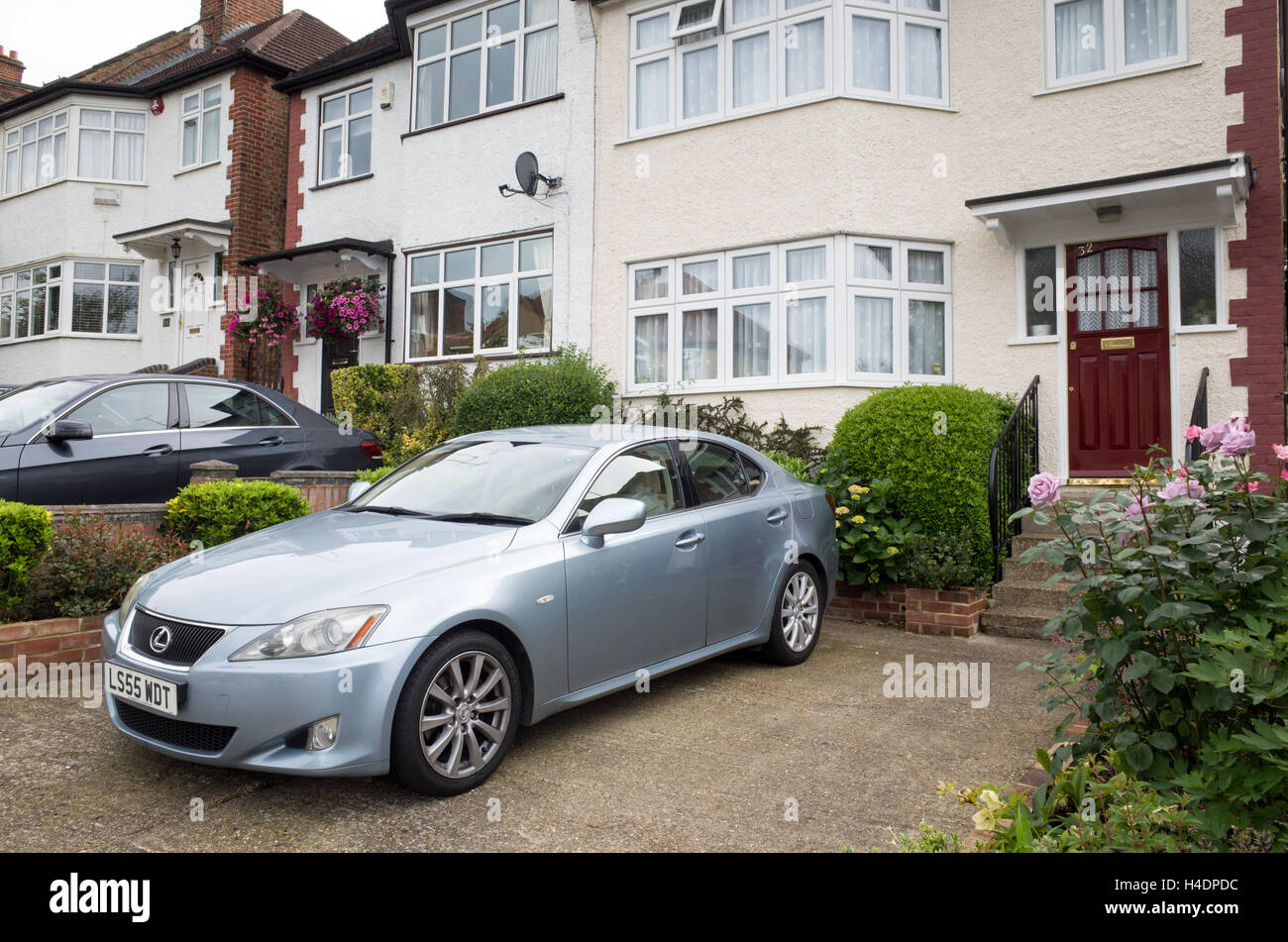 Cars parked on the front drive of houses in Barnet, North London, England, UK Stock Photo