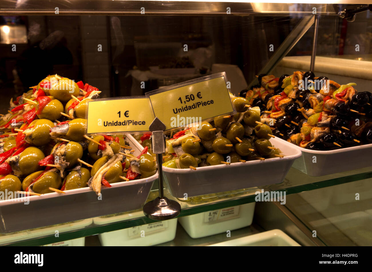 Display of a variety of olives, stuffed with seafood. Stock Photo