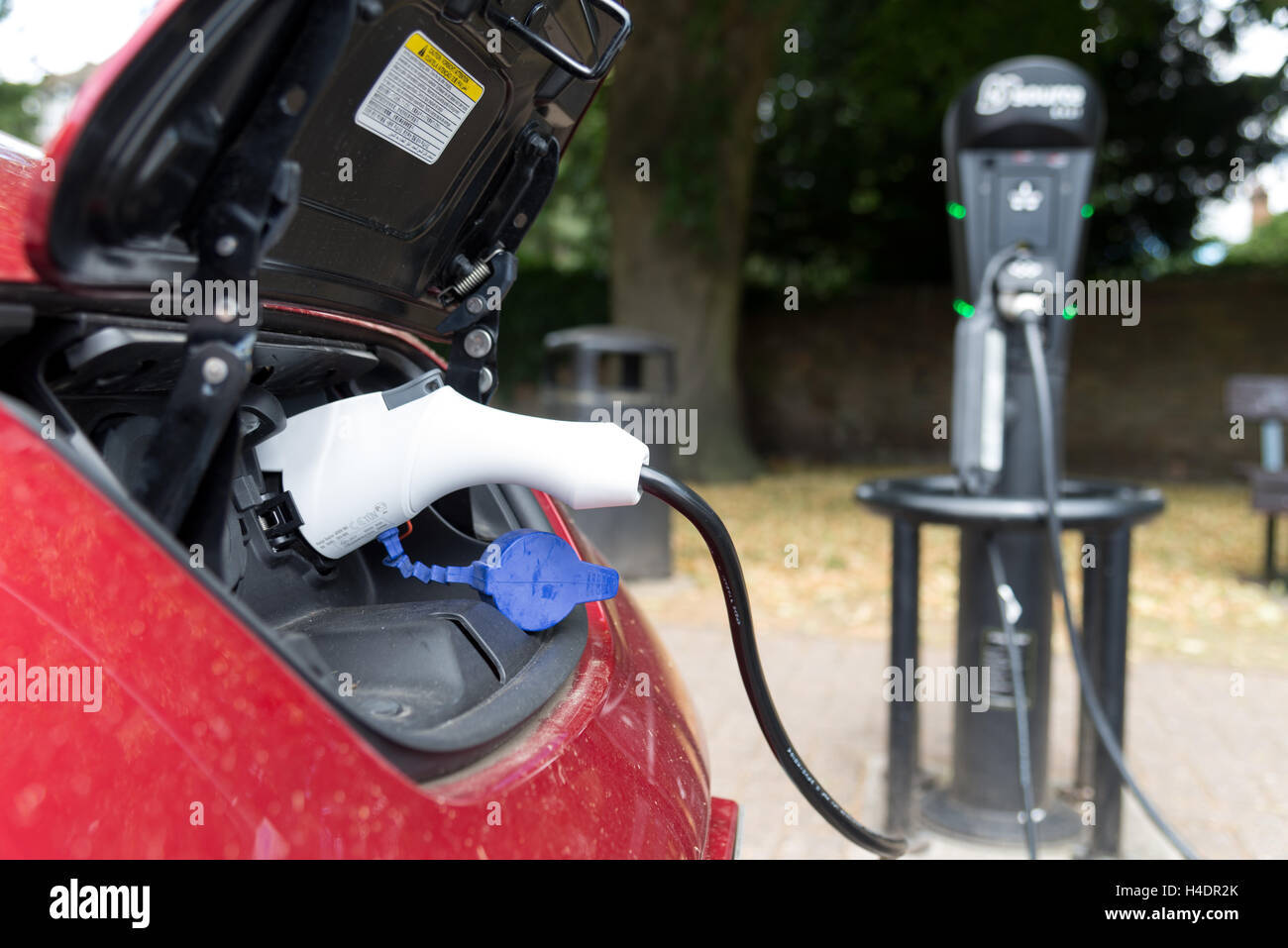 Electric car being charged at charging point on roadside in St Albans, England, UK Stock Photo