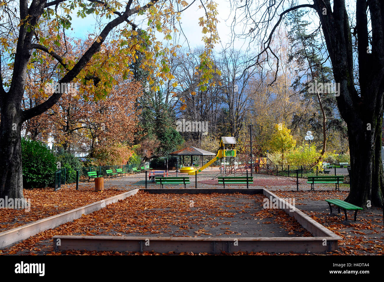 Deserted children's playground at autumn season Stock Photo