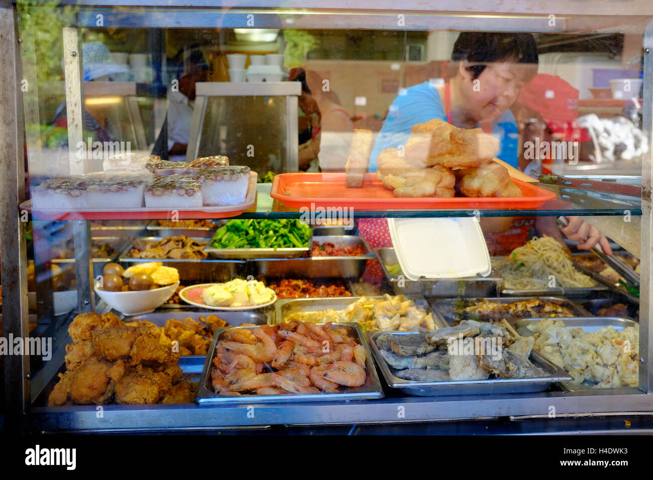 Food display inside of the window of a Chinese buffet restaurant in East Broadway,Chinatown,Manhattan,New York,USA Stock Photo