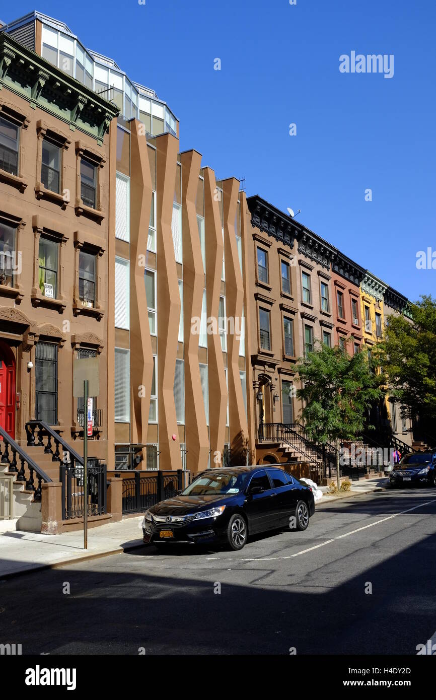 A newly built house among renovated classic brownstone apartment