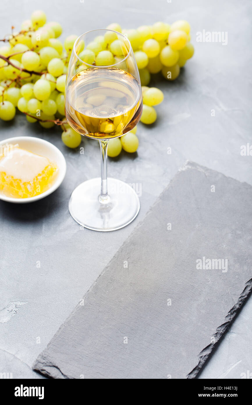 Glass of white wine and assorted cheese Stock Photo