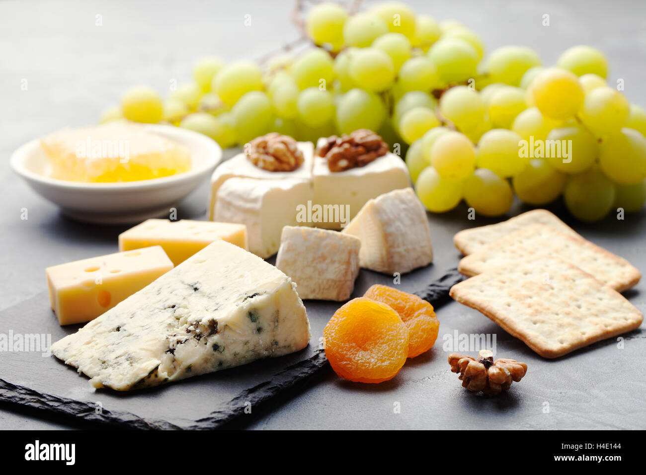 Glass of white wine and assorted cheese Stock Photo