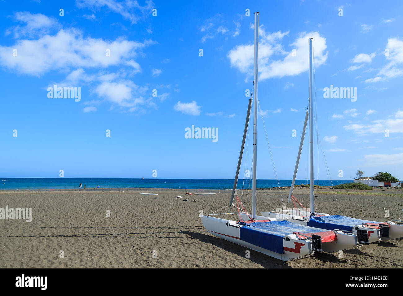 Catamaran boats on black sand volcanic beach in Las Playitas village, Fuerteventura, Canary Islands, Spain Stock Photo