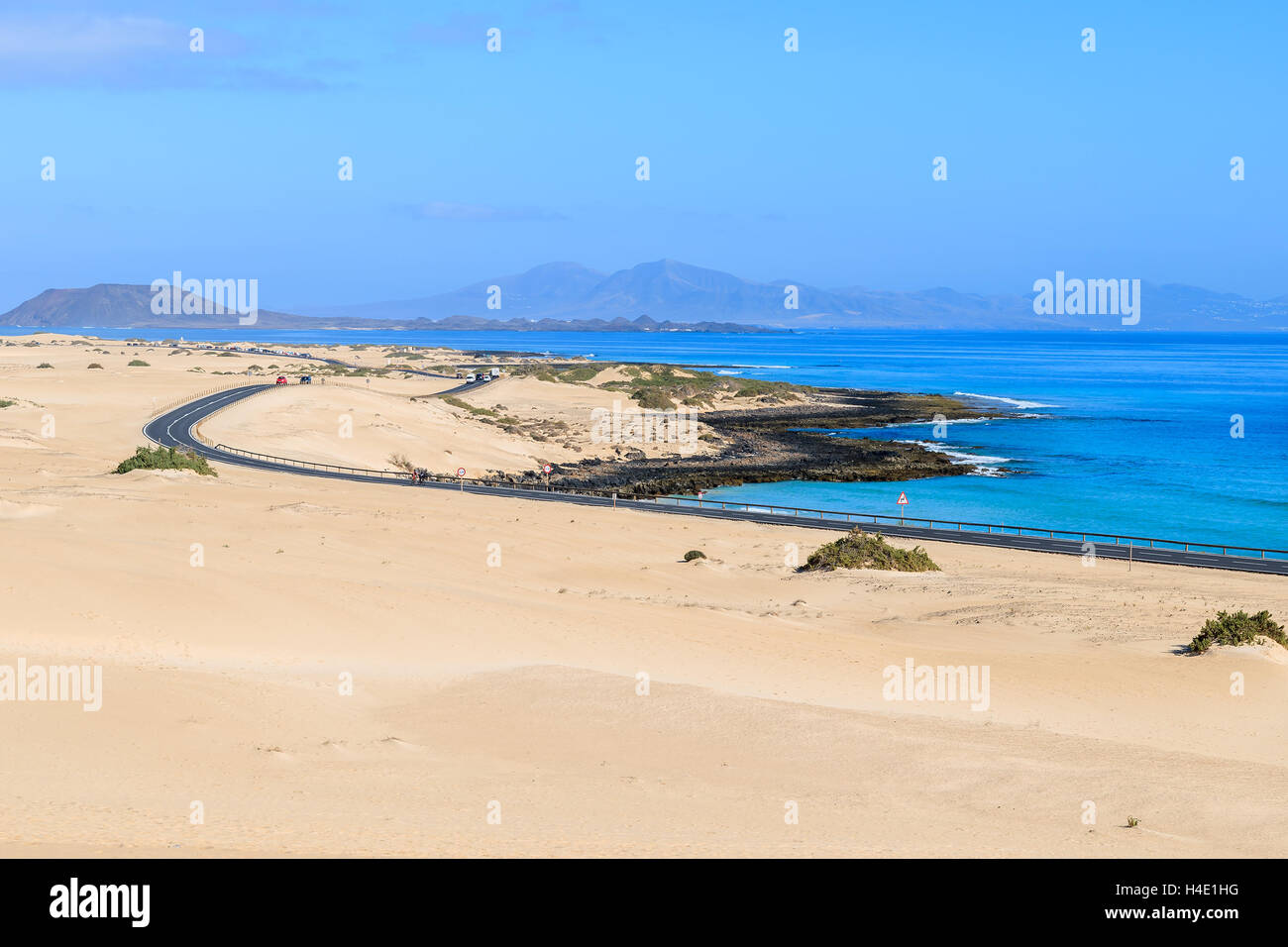 Sand dunes in Corralejo National Park and view of sea and road, Fuerteventura, Canary Islands, Spain Stock Photo