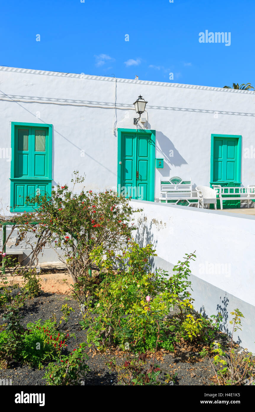 Typical Canary style white house with green doors and windows in rural area of La Oliva village, Fuerteventura, Canary Islands, Spain Stock Photo