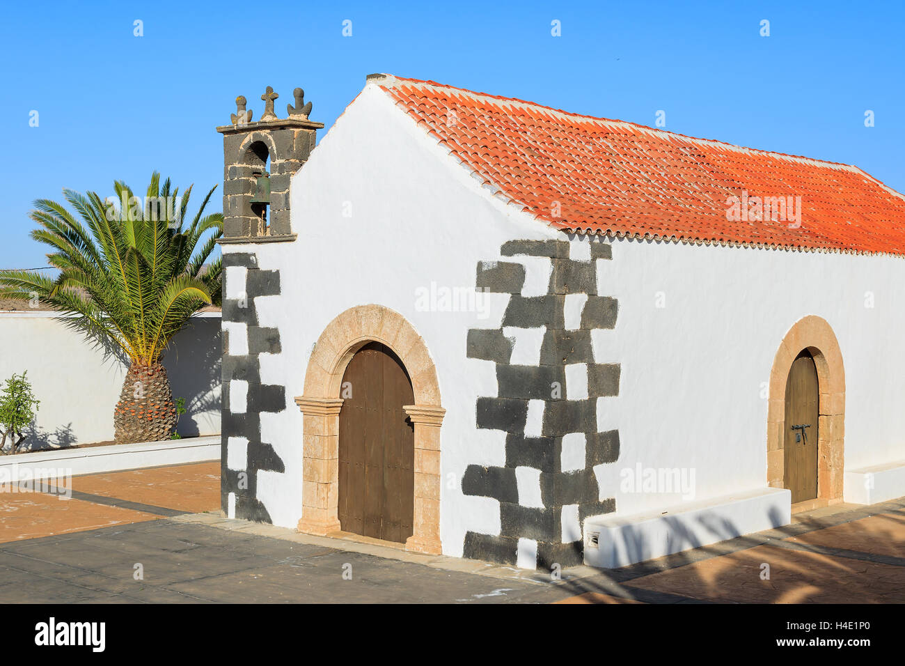 Palm trees and typical Canary style white church building in Tindaya village, Fuerteventura, Canary Islands, Spain Stock Photo