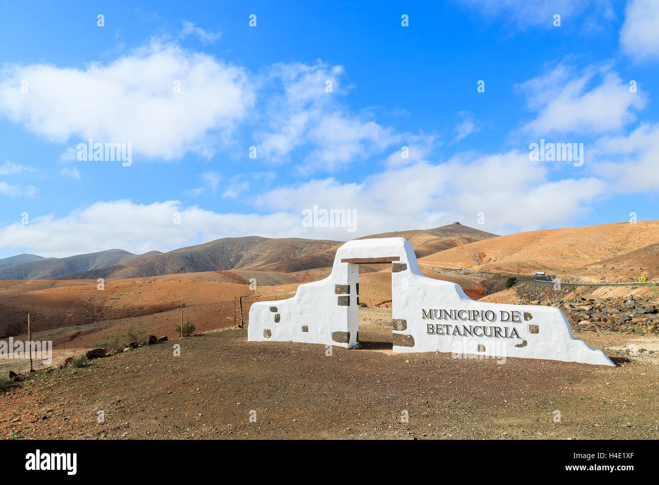 Traditionall municipality sign (white arch gate) near Betancuria village with desert landscape in the background, Fuerteventura, Canary Islands, Spain Stock Photo