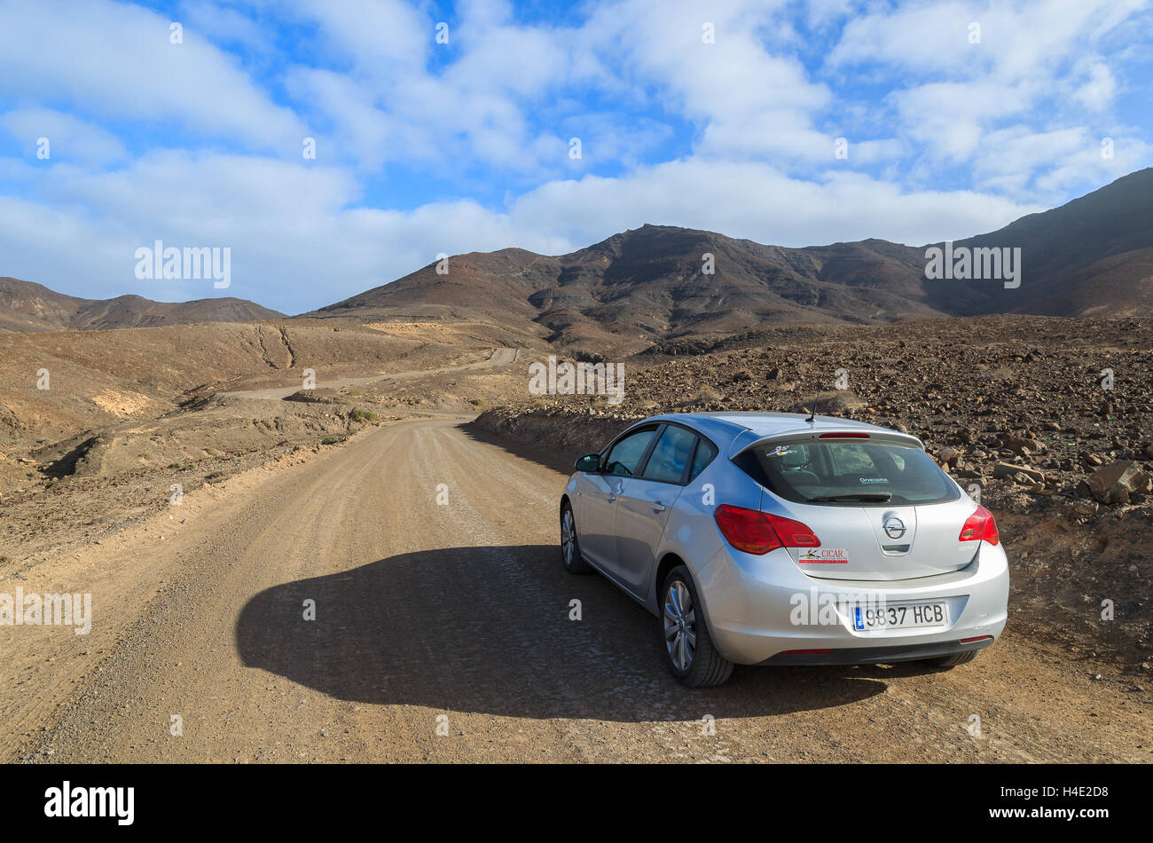 Hire car on unpaved road to Cofete beach and volcanic landscape near Morro Jable town, Fuerteventura, Canary Islands, Spain Stock Photo