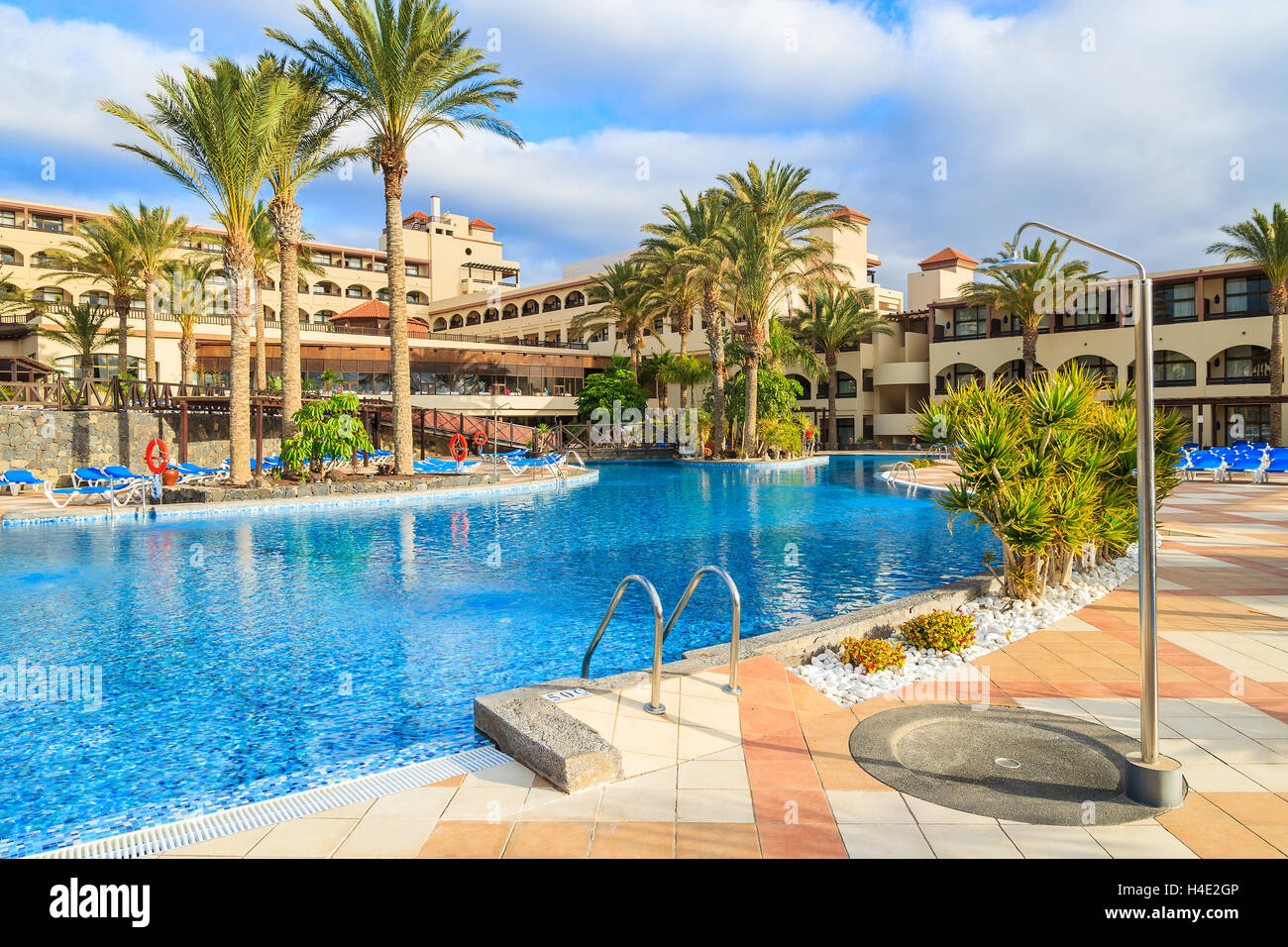 MORRO JABLE, FUERTEVENTURA - FEB 6, 2014: swimming pool of a luxury hotel Barcelo Jandia Mar in town of Morro Jable. This is a popular holiday destination for tourists on Fuerteventura island. Stock Photo