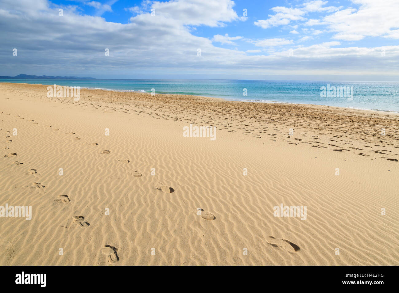 Footprints in sand on and beautiful turquoise sea on Jandia beach, Morro Jable, Fuerteventura, Canary Islands, Spain Stock Photo