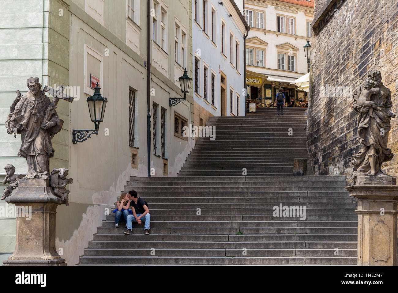 Couple kissing  on the Radniční stairs, in the Castle district (Hradčany), flanked by St John and St Joseph. Stock Photo
