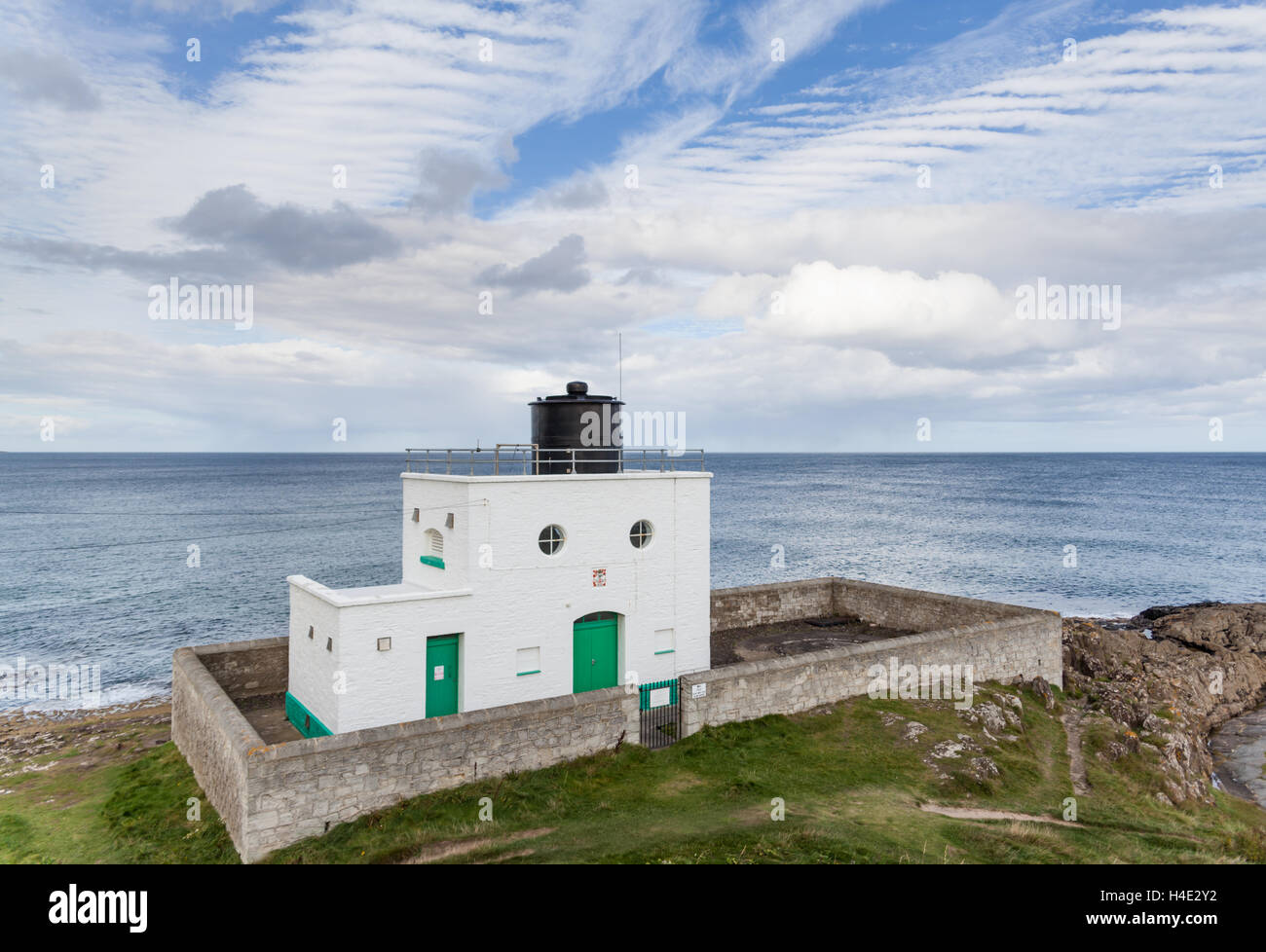 Stag Rock lighthouse on a summer's day under a mackerel sky on the