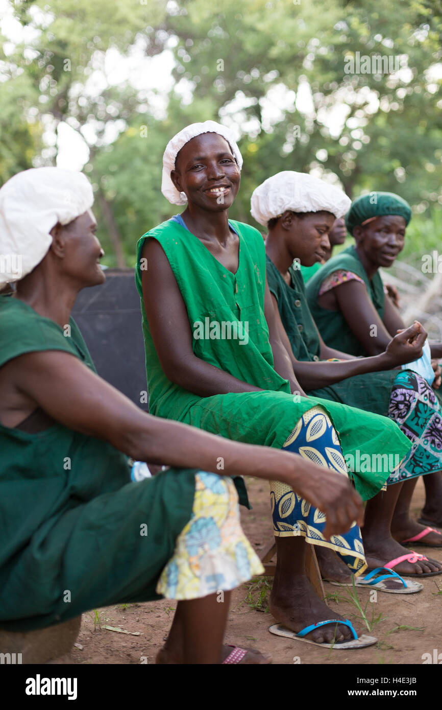 Employees sit together at a fair trade shea butter production facility in Réo, Burkina Faso, West Africa. Stock Photo