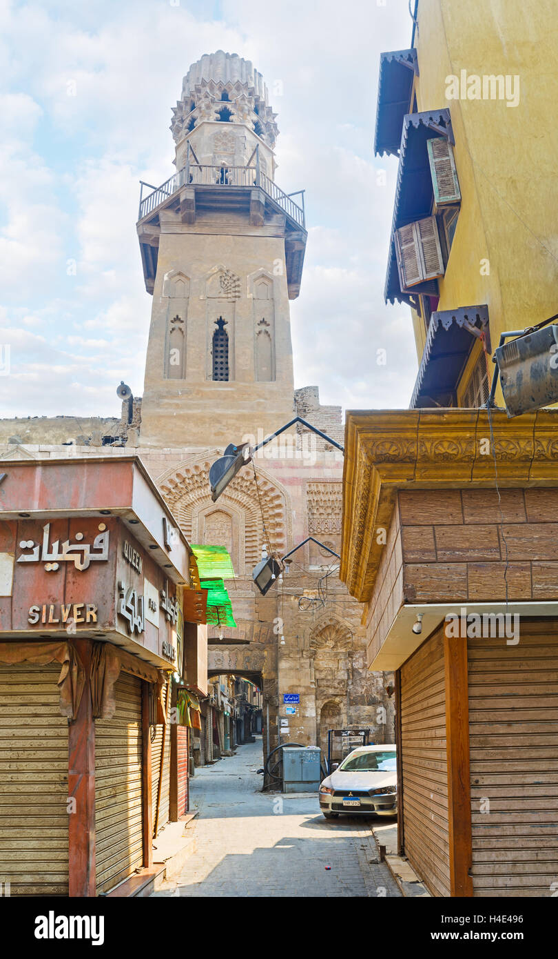 The entrance of Al Salheyya alley, branching from Al-Moaz street is topped by old minaret, Cairo Egypt Stock Photo