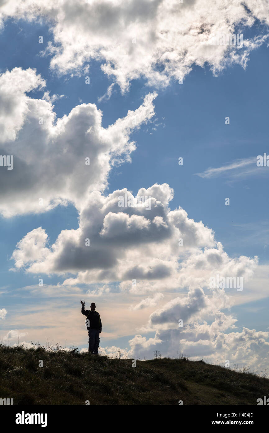 Man waving on cliff top, Tennyson Down, Isle of Wight, UK Stock Photo
