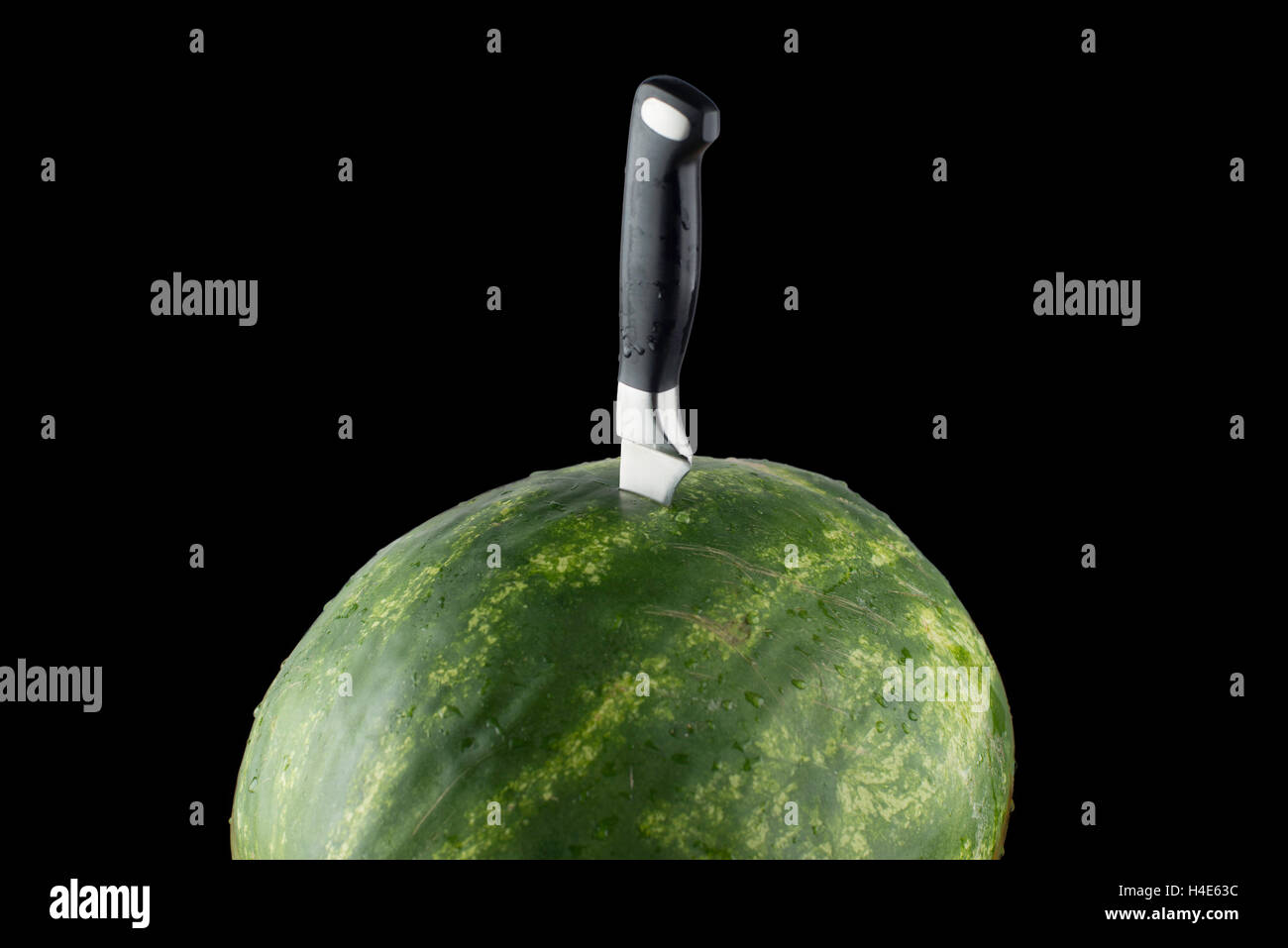 isolated Riped watermelon with knife and black background Stock Photo ...