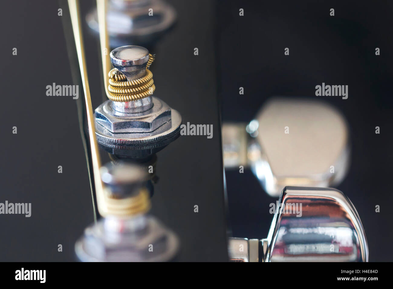 Silver tuner post from a guitar. Stock Photo