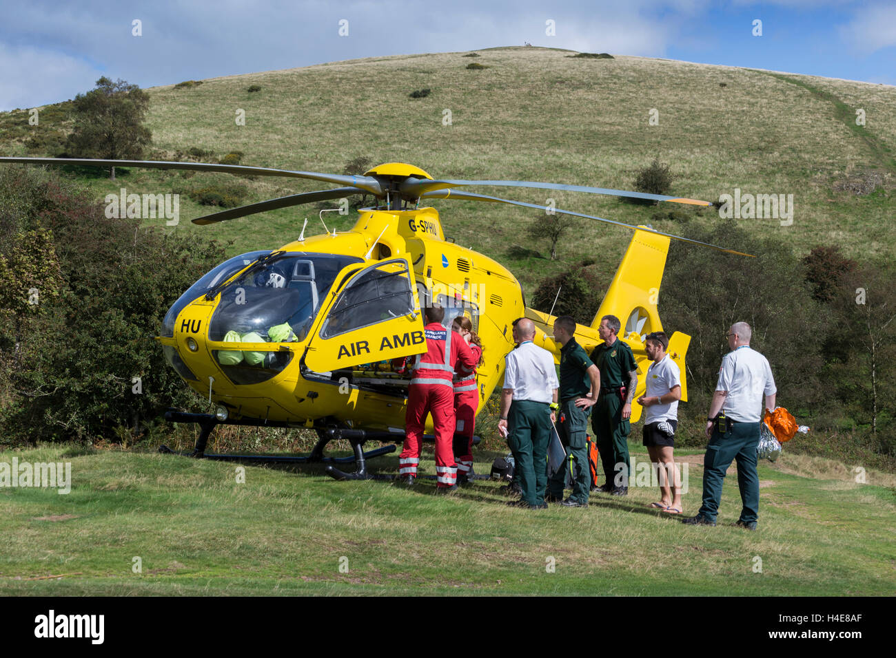 Air ambulance attending ill walker on Malvern Hills Worcestershire Stock Photo